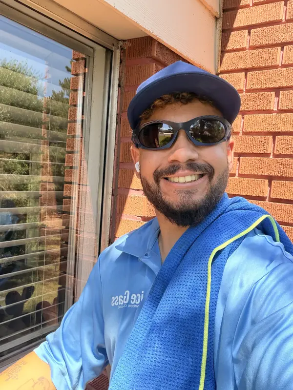 Mike, owner of Nice Glass Window Cleaning, smiling on a job in Salt Lake City
