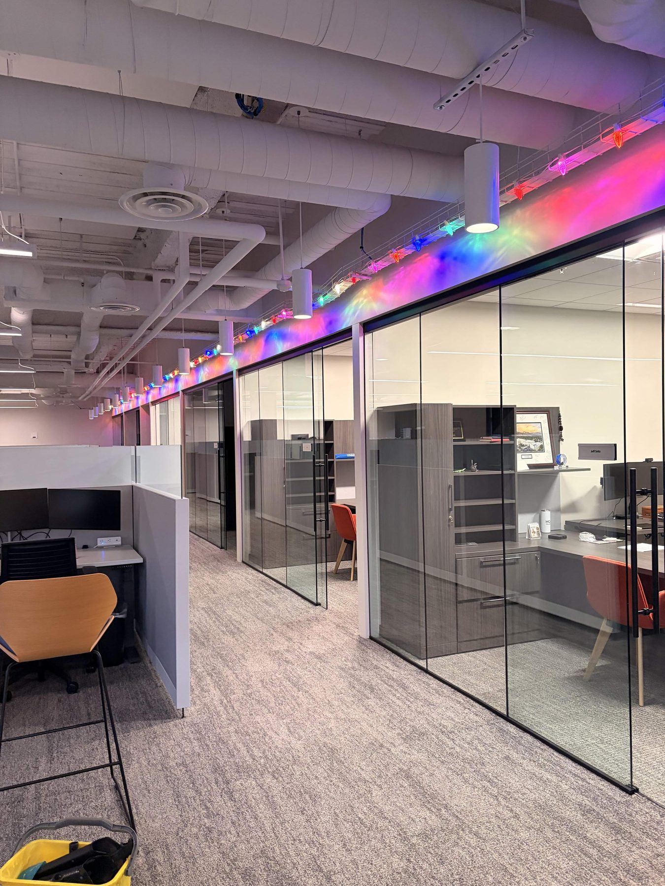 Streak-free interior glass wall cleaning along a downtown Salt Lake City office corridor, clear through the partitions to the offices beyond