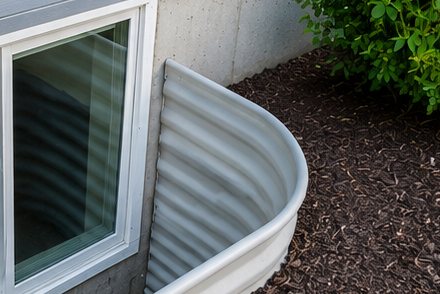 Corrugated window well liner cleaned during basement window well clearing in Salt Lake County