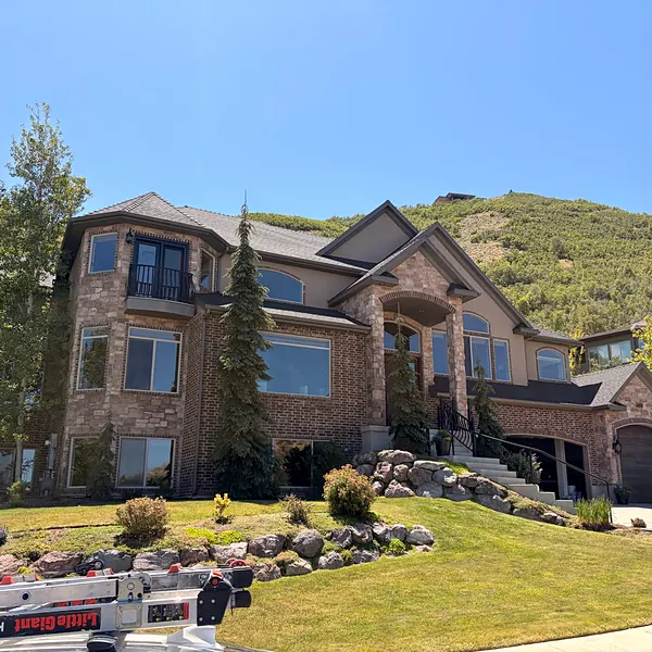 Window cleaning on a brick and stone home in the Utah foothills
