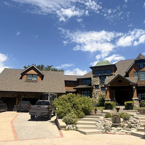 Window cleaning on a large stone and cedar home