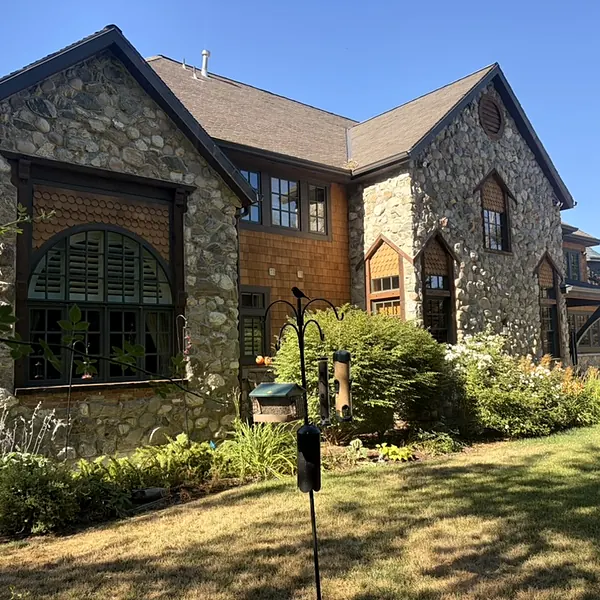 Clean windows on a stone cottage-style home