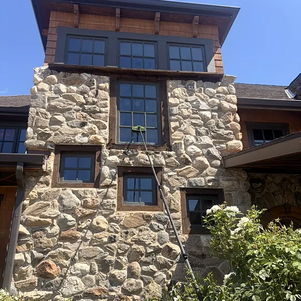 Cleaning high windows with a water-fed pole