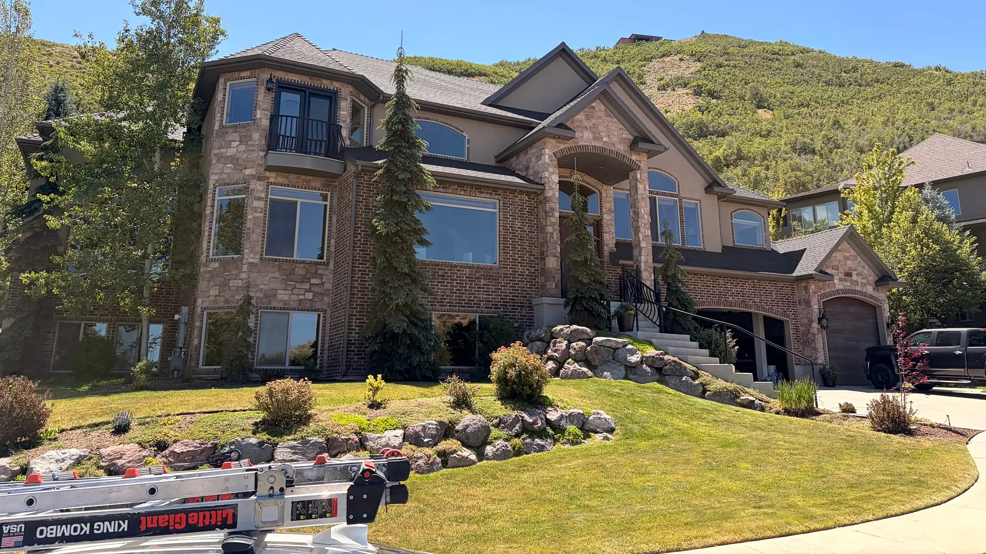 Window cleaning on a brick and stone home in the Utah foothills