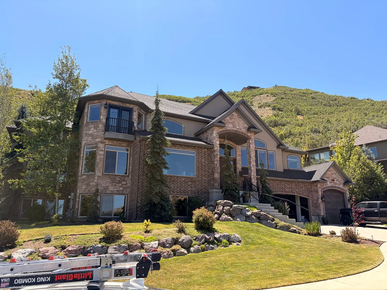 Window cleaning on a brick and stone home in the Utah foothills